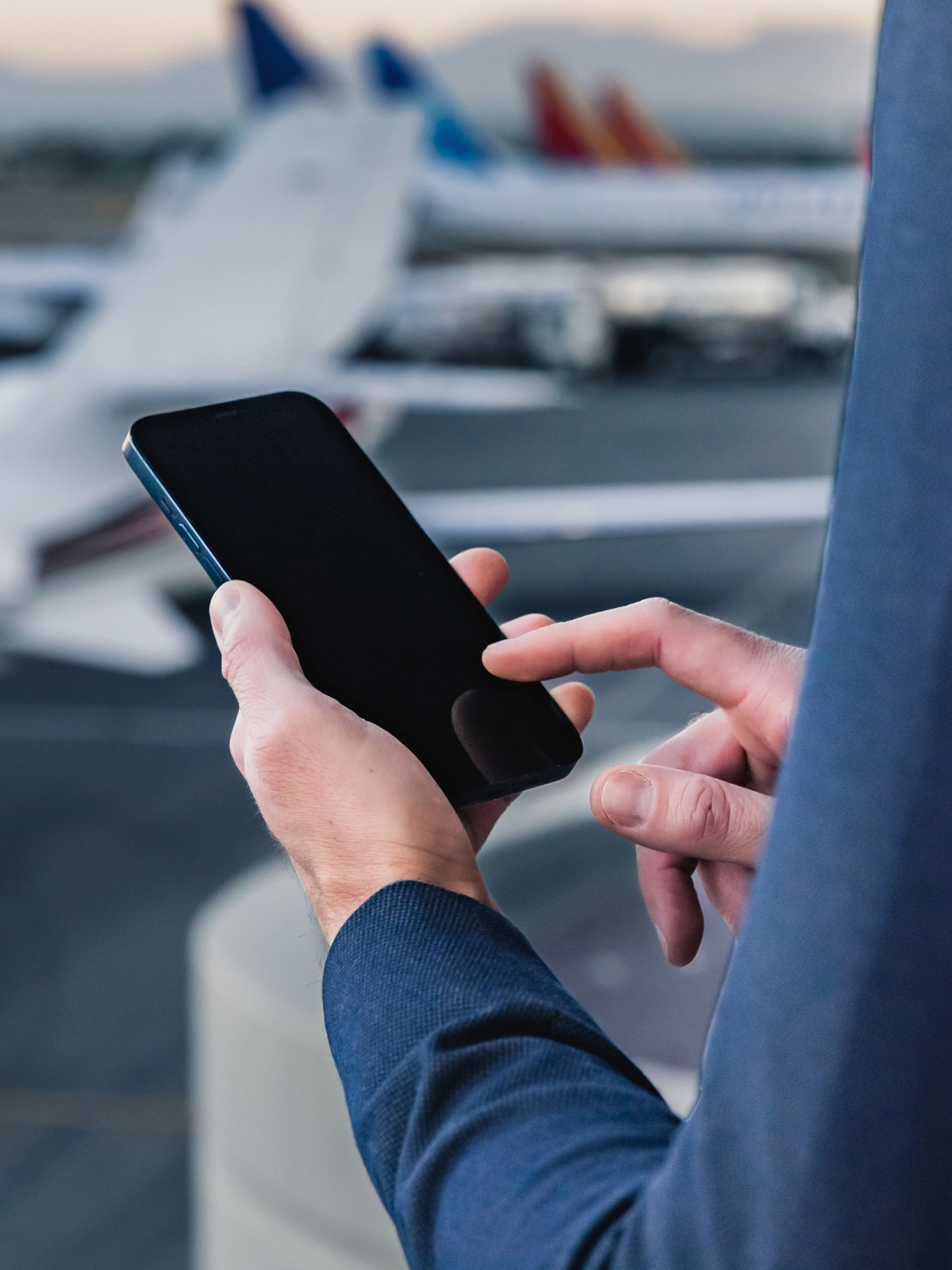 An image of hands holding an iPhone.
