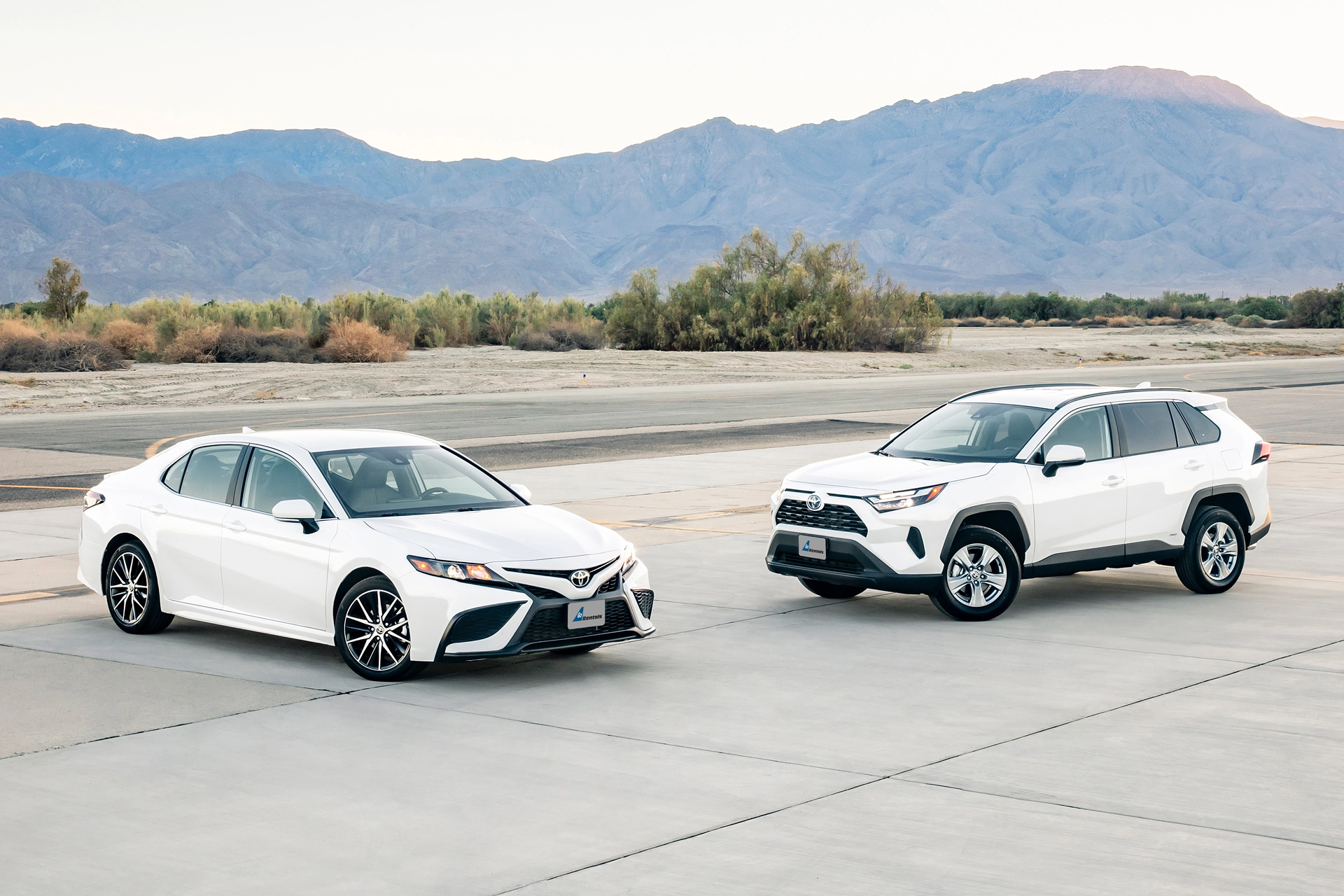 An image of two white, casual cars.